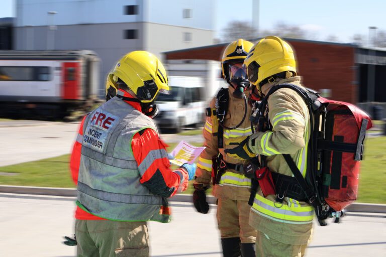 firefighters gathered around incident commander.